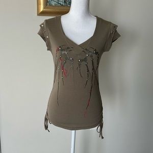 Super cute top with embellishments and side ties